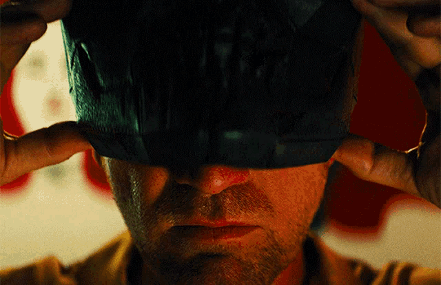 a close up of a man 's face with a mask on
