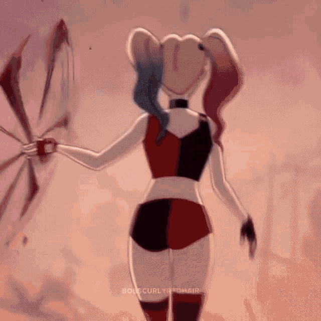 harley quinn is holding a fan in her hand while walking in the desert .