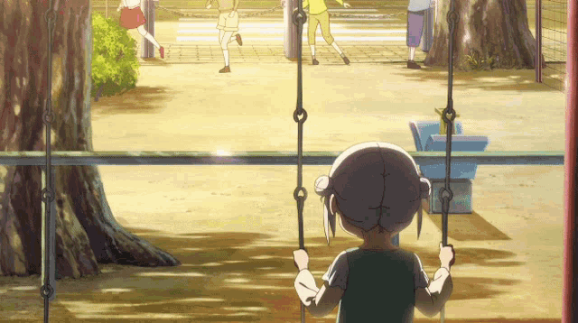 a girl sitting on a swing in a park