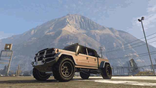 a jeep is parked in front of a mountain in a parking lot