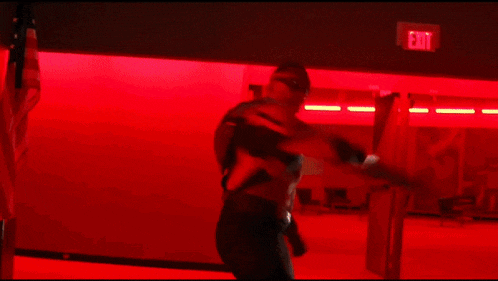 a blurred image of a person in a room with red lights