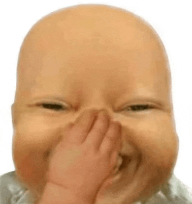a baby is covering his nose with his hand while making a funny face .