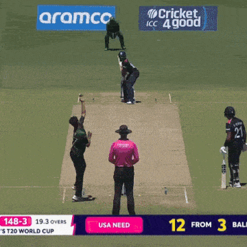 a cricket game is being played in front of a aramco banner