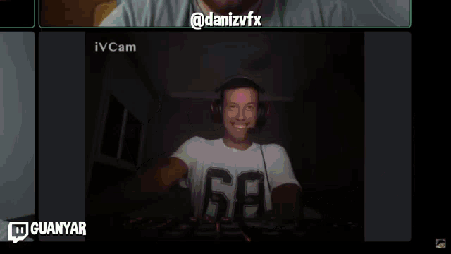 a man wearing headphones is smiling in front of a screen that says danizvfx
