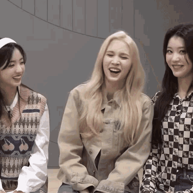 three girls are laughing together and one has a shirt that says ' sbs ' on it
