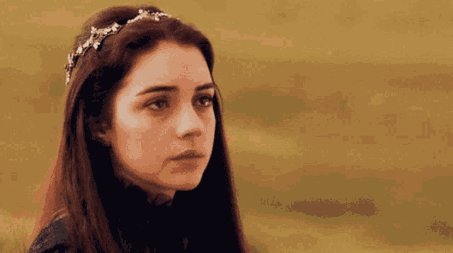 a close up of a woman wearing a tiara