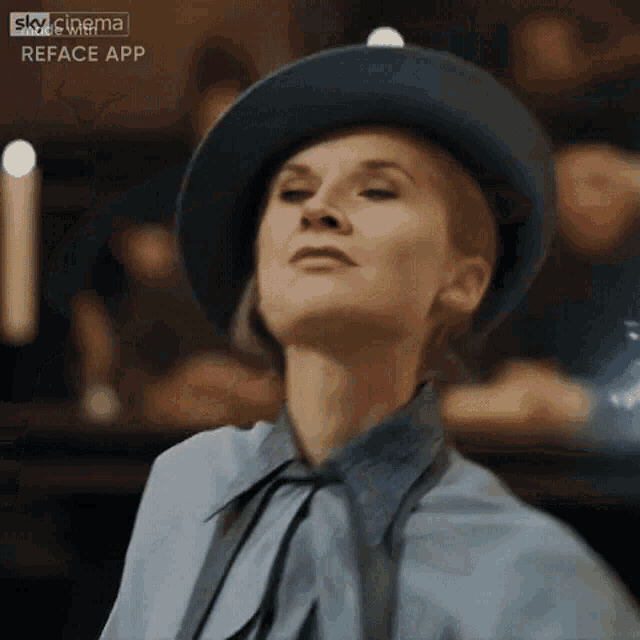 a woman wearing a blue hat and a blue shirt is looking up .