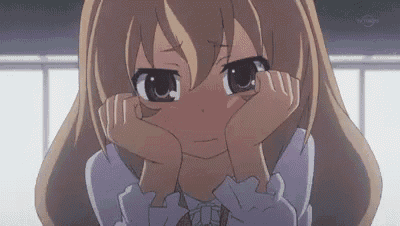 a girl with long hair is covering her face with her hands and looking sad .