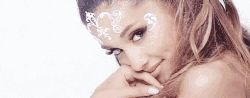 ariana grande is wearing white makeup on her face .