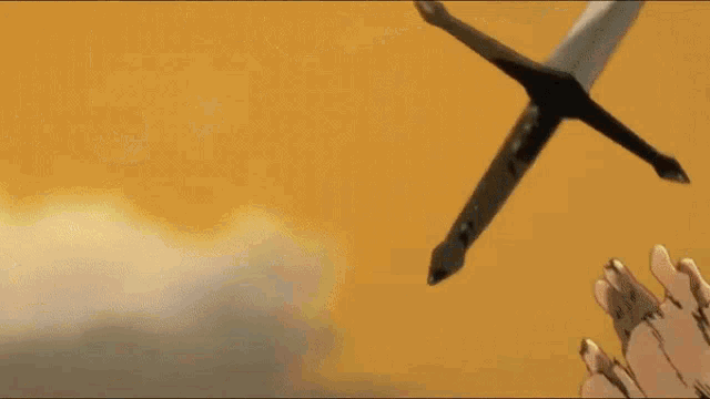 a sword is flying through the air with a cloudy sky in the background