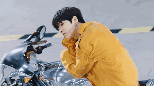 a man riding a motorcycle with a smiley face on the wall behind him