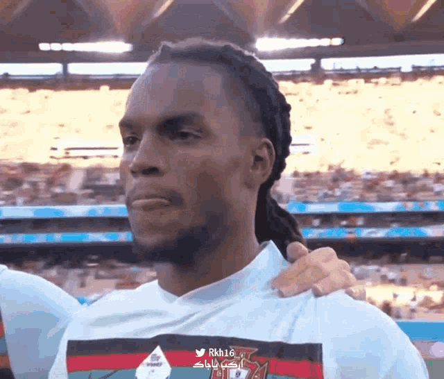 a man with dreadlocks is wearing a shirt that says rhh16 on it