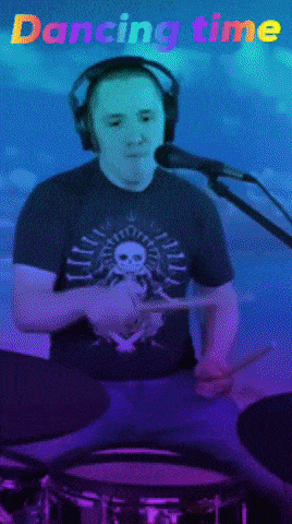 a man is playing drums and singing into a microphone with the words dancing time above him