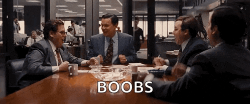 a group of men are sitting around a table and the word boobs is on the bottom