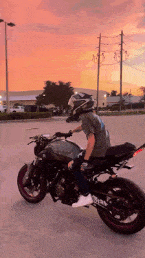 a man is riding a motorcycle with a helmet on