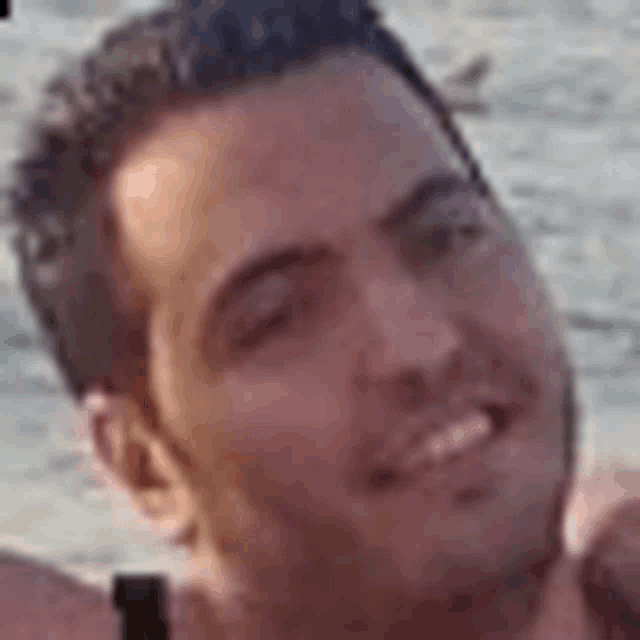 a close up of a man 's face with a blurred background .