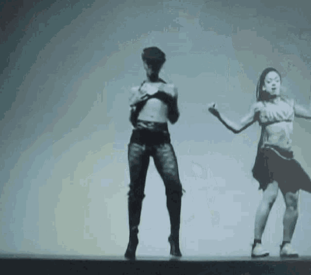 a black and white photo of two women dancing on a stage with a white background