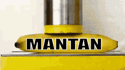 a banana is being pressed by a yellow object that says mantan