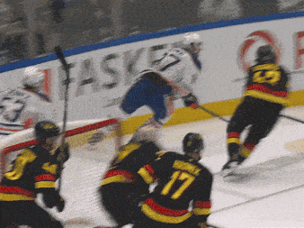 a hockey player with the number 17 on his jersey is jumping in the air