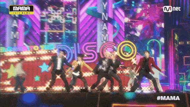 a group of people dancing on a stage with a sign that says disco