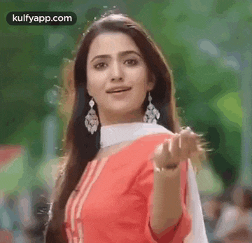 a woman in a red and white dress is making a funny face .