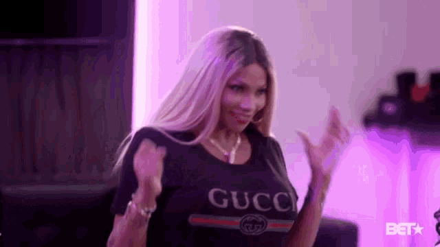a woman wearing a black shirt that says gucc on it