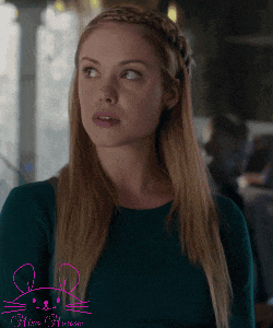 a woman with a braided headband and a mouse on her sleeve