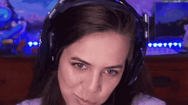 a close up of a woman wearing headphones that say astro on them