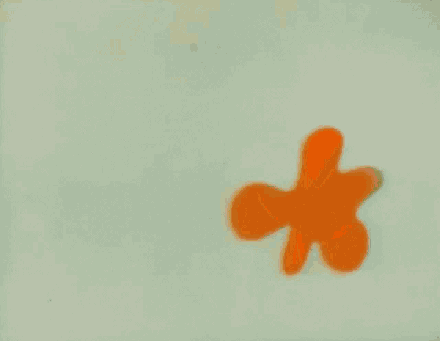 a cartoon character with a purple hat is standing next to an orange object that says love