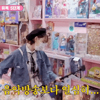 a woman wearing a mask is standing in front of a display of dolls