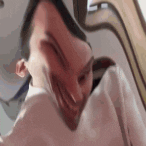 a close up of a person 's face with a strange face .