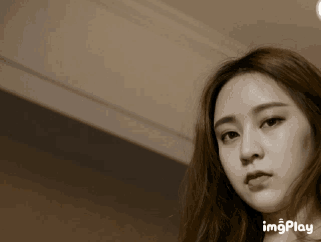 a close up of a woman 's face with the words imgplay visible in the corner