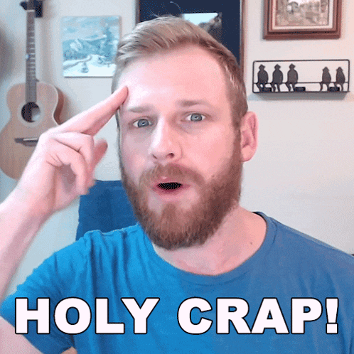 a man with a beard is pointing at his forehead with the words holy crap written below him