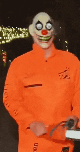 a man in a clown costume has the word fear on his sleeve
