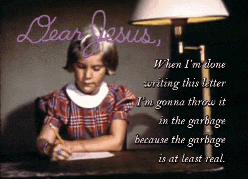 a girl is writing a letter to dear jesus while sitting at a desk