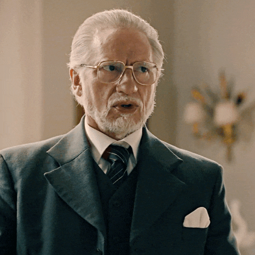 a man with glasses and a beard looks surprised