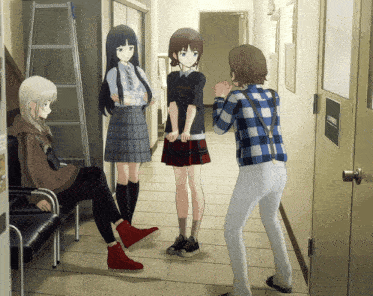 a girl wearing a black shirt that says " i love you " talks to two other girls