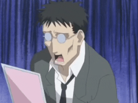 a man in a suit and tie is looking at a pink piece of paper