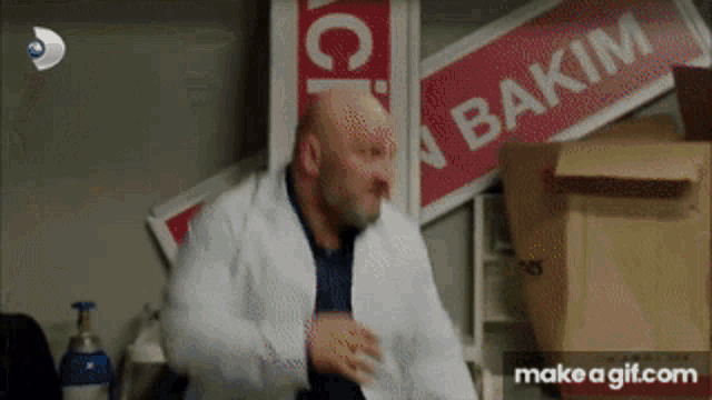 a man in a lab coat is standing in front of a sign that says " bakim " on it