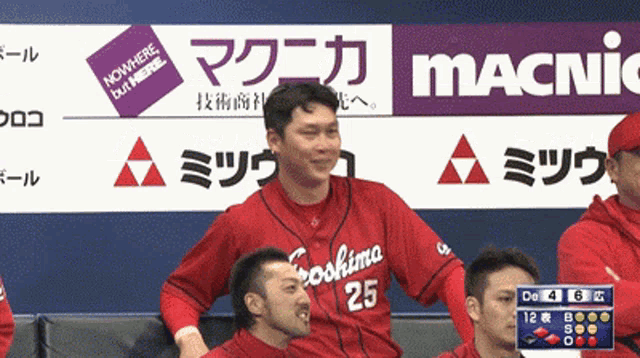 a baseball player wearing a red uniform with the number 25 on it