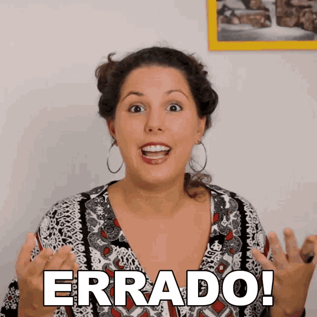 a woman is making a funny face with the words " errado " written on her face