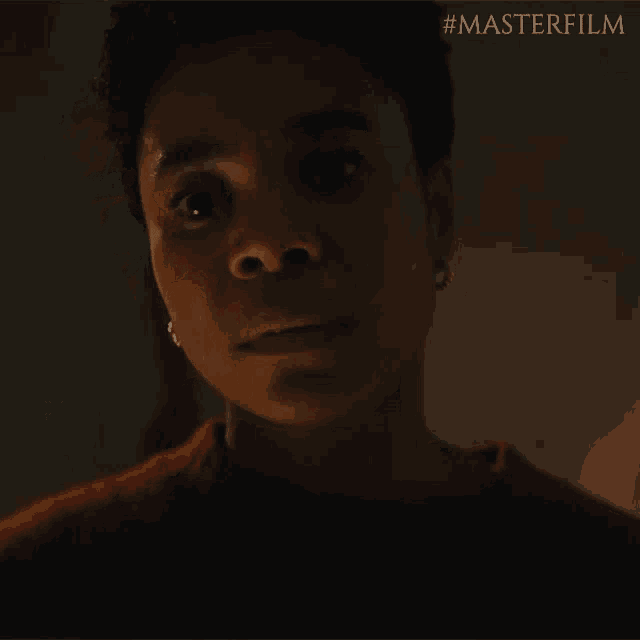 a close up of a woman 's face with #masterfilm written on the bottom right