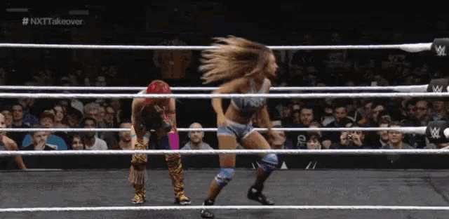 two women in a wrestling ring with the words nxt takeover