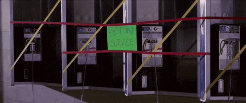a row of pay phones with a sign that says " not in service "