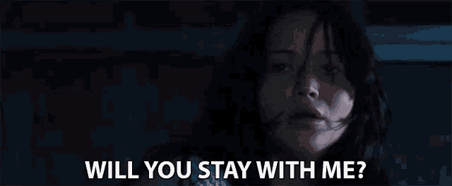 a woman is sitting in a dark room and asking if she can stay with her .