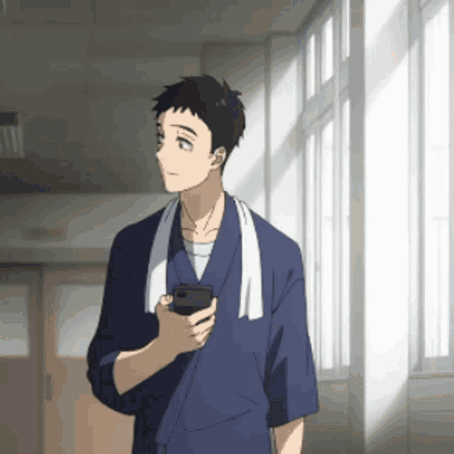 a man with a towel around his neck is holding a phone