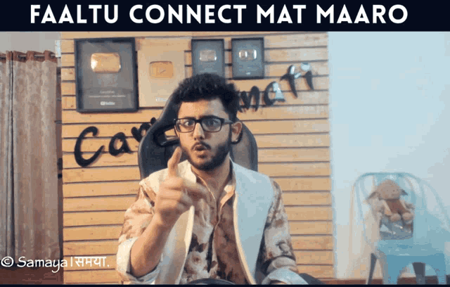 a man giving a thumbs up in front of a wall that says " connect "
