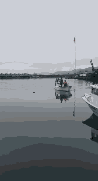 a group of people are in a boat in the water