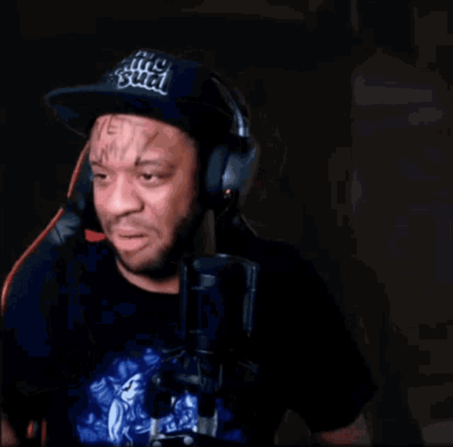 a man wearing headphones says " oh god fuck " in front of a microphone