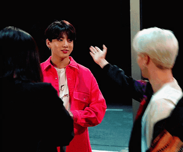 a man wearing a pink shirt that says " i love you "